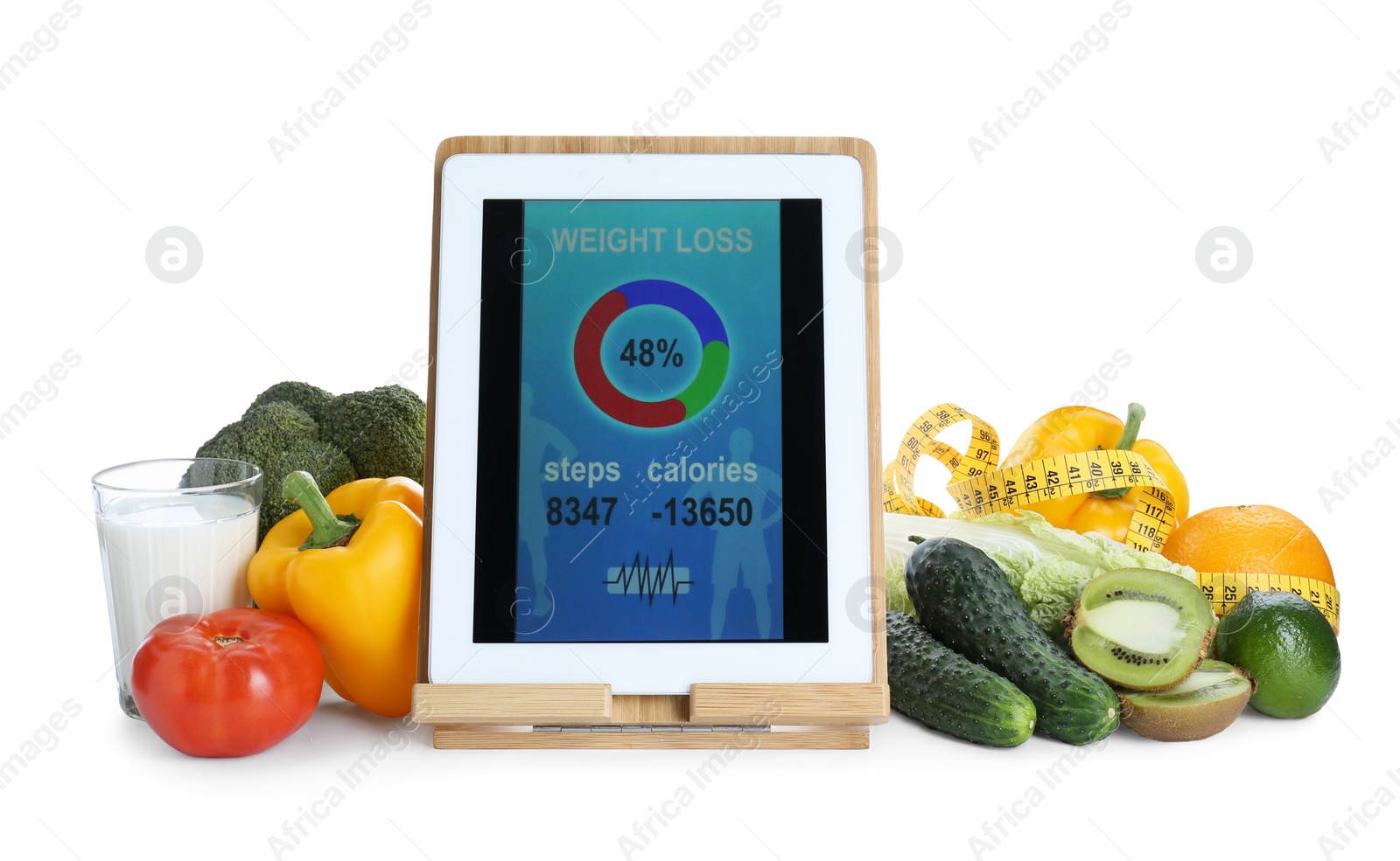 Photo of Tablet with weight loss calculator application, measuring tape and food products on white background