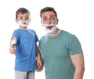 Photo of Dad and his little son with shaving foam on faces against white background