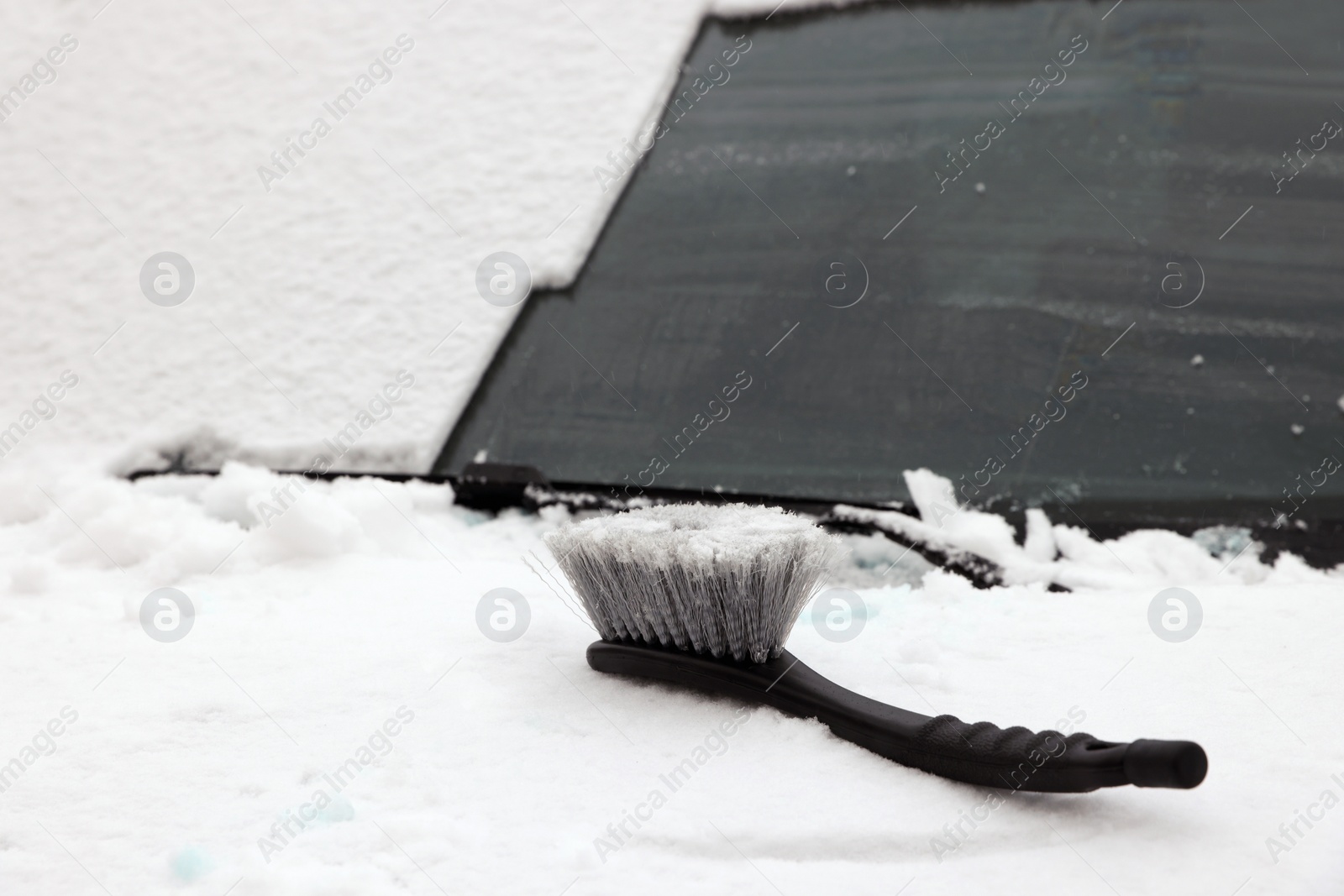 Photo of Car covered with snow and brush, closeup