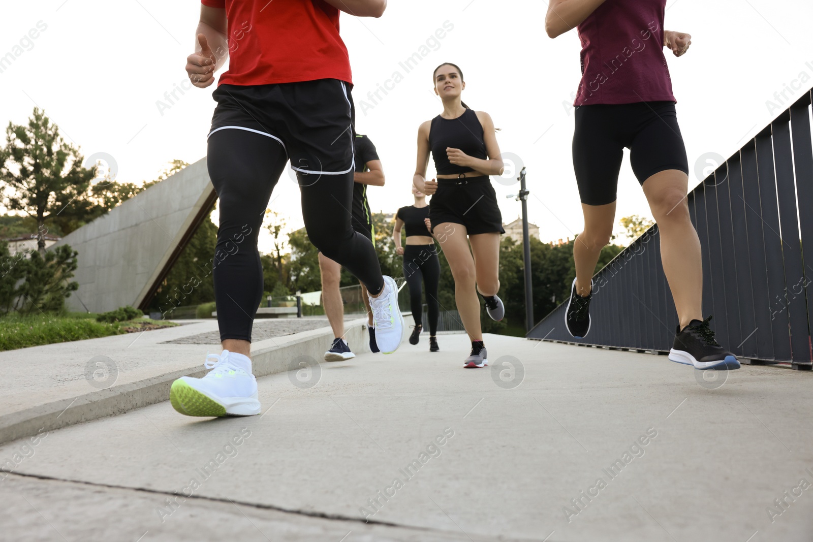 Photo of Group of people running outdoors. Active lifestyle