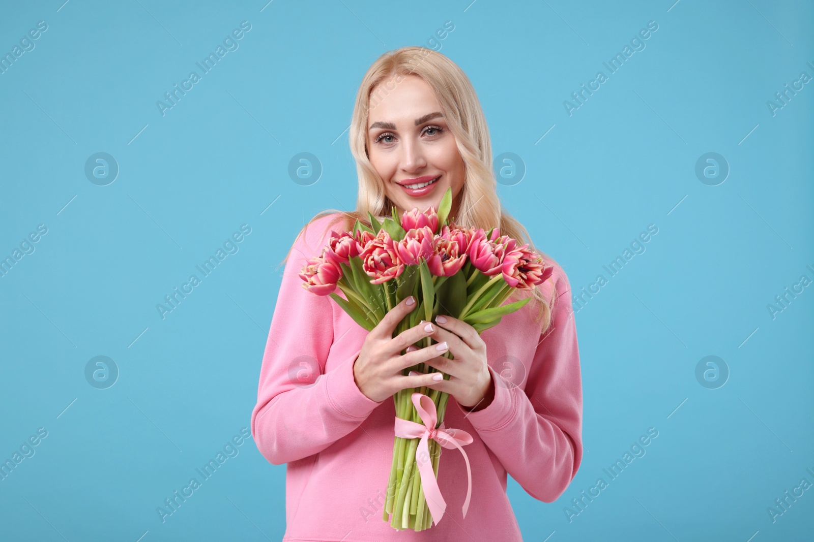 Photo of Beautiful young woman on light blue background