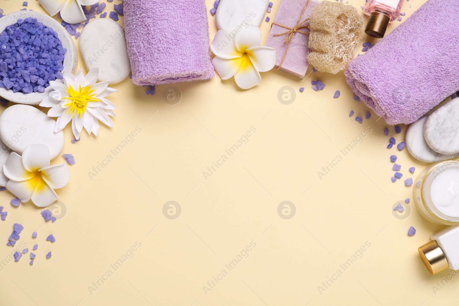 Photo of Flat lay composition with spa accessories on beige background. Space for text