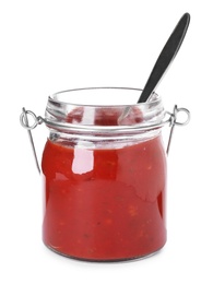 Photo of Glass jar with red sauce and spoon on white background