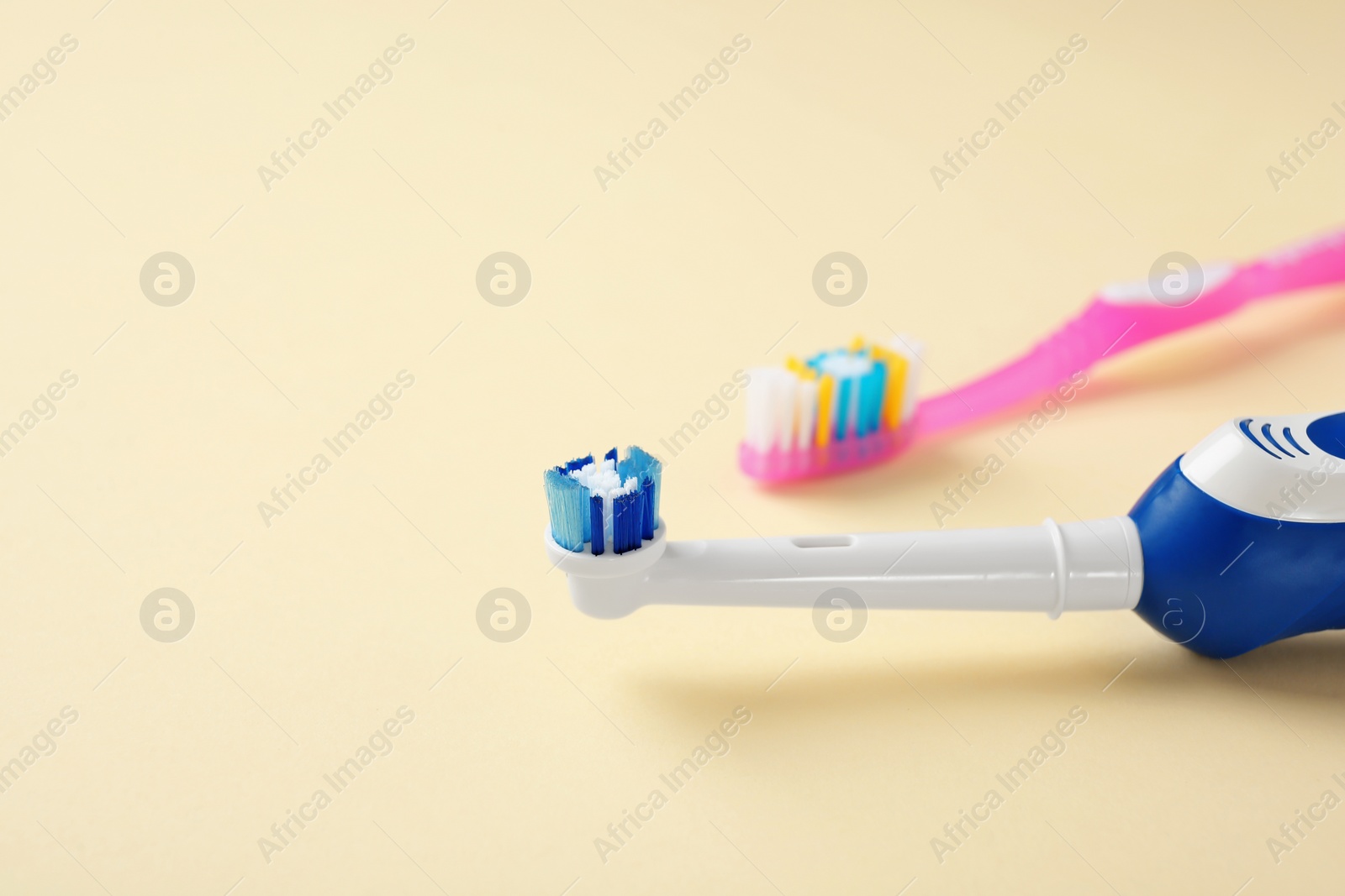 Photo of Manual and electric toothbrushes on color background. Dental care