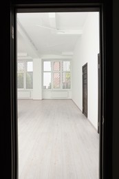 Photo of Modern office room with windows and door, view from entrance. Interior design