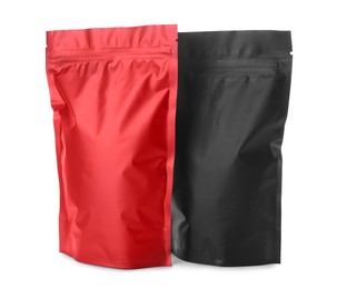 Photo of Black and red resealable foil packages isolated on white