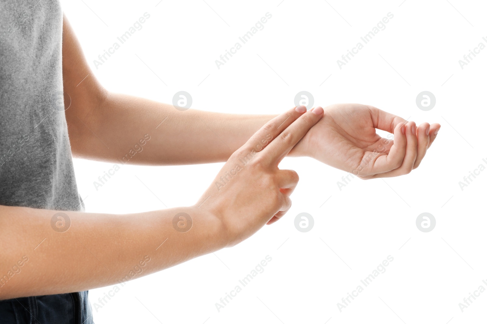 Photo of Woman checking pulse on wrist against white background, closeup