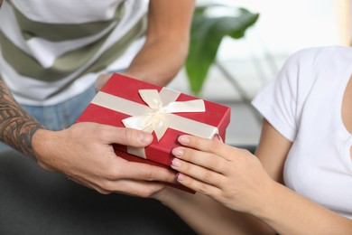 Photo of Lovely couple with beautiful gift, closeup view