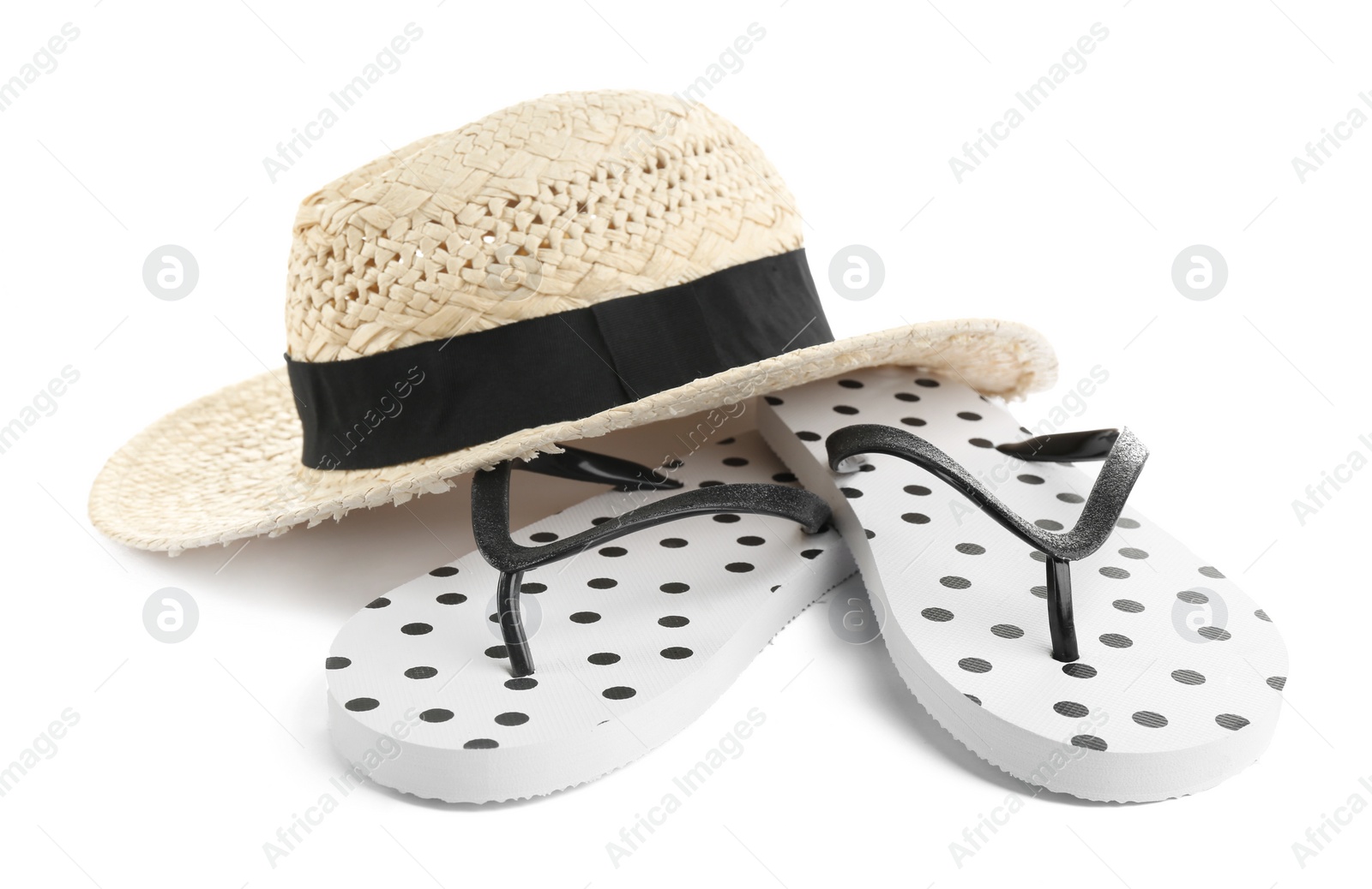 Photo of Stylish flip flops and hat on white background