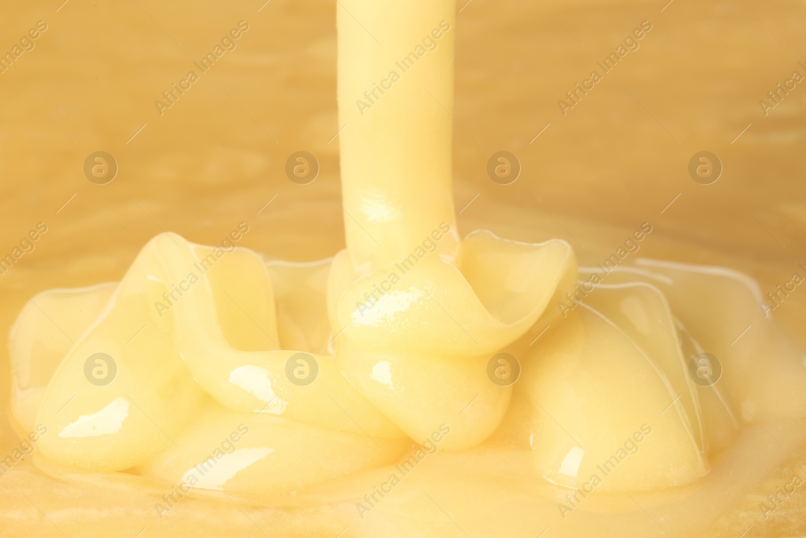 Photo of Pouring fresh sweet honey, closeup