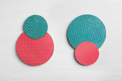 Photo of Red and green circles on white wooden background, flat lay. Pareto principle concept
