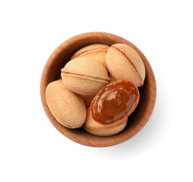 Photo of Delicious nut shaped cookies with boiled condensed milk in wooden bowl on white background, top view