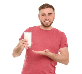 Photo of Young man with glass of tasty milk on white background