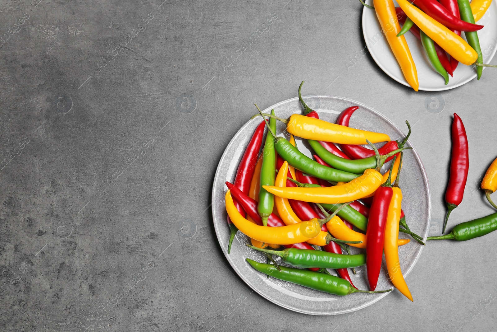 Photo of Flat lay composition with chili peppers on grey background