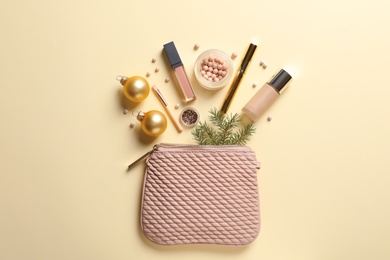 Photo of Flat lay composition with makeup products and Christmas decor on color background