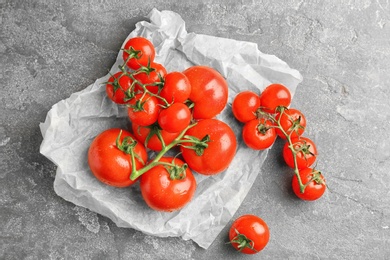 Photo of Fresh ripe tomatoes on grey background, top view