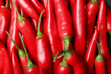 Ripe hot chili peppers as background, closeup