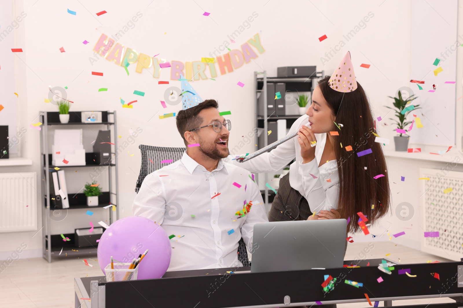 Photo of Coworkers having fun during office party indoors