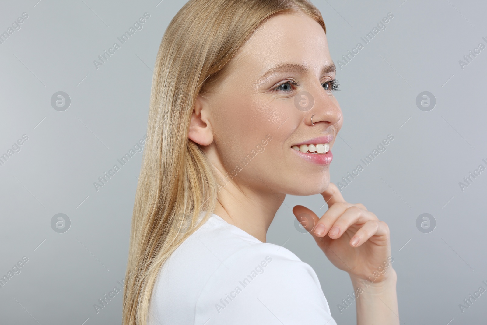 Photo of Portrait of beautiful young woman on grey background