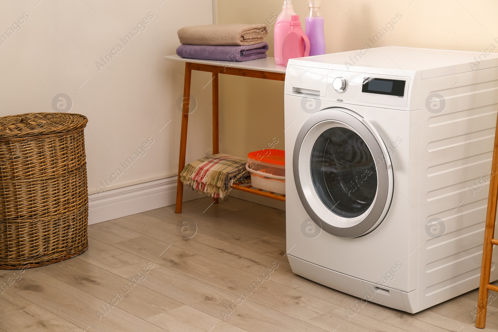Photo of Laundry room interior with modern washing machine