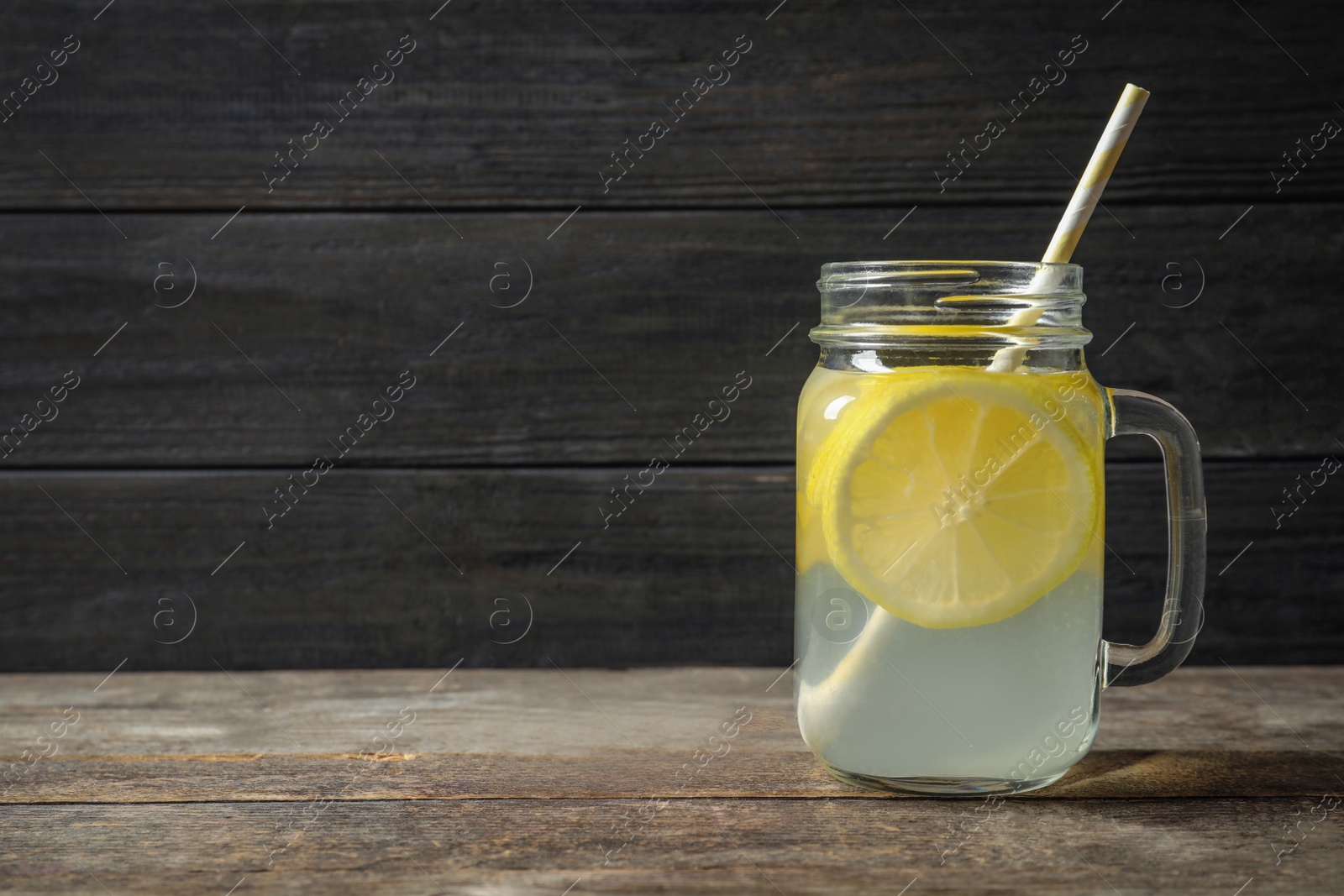 Photo of Natural lemonade in mason jar on wooden table