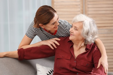 Photo of Elderly woman with female caregiver in living room