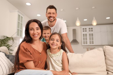 Photo of Portrait of happy family on sofa at home