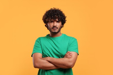 Portrait of handsome young man on yellow background