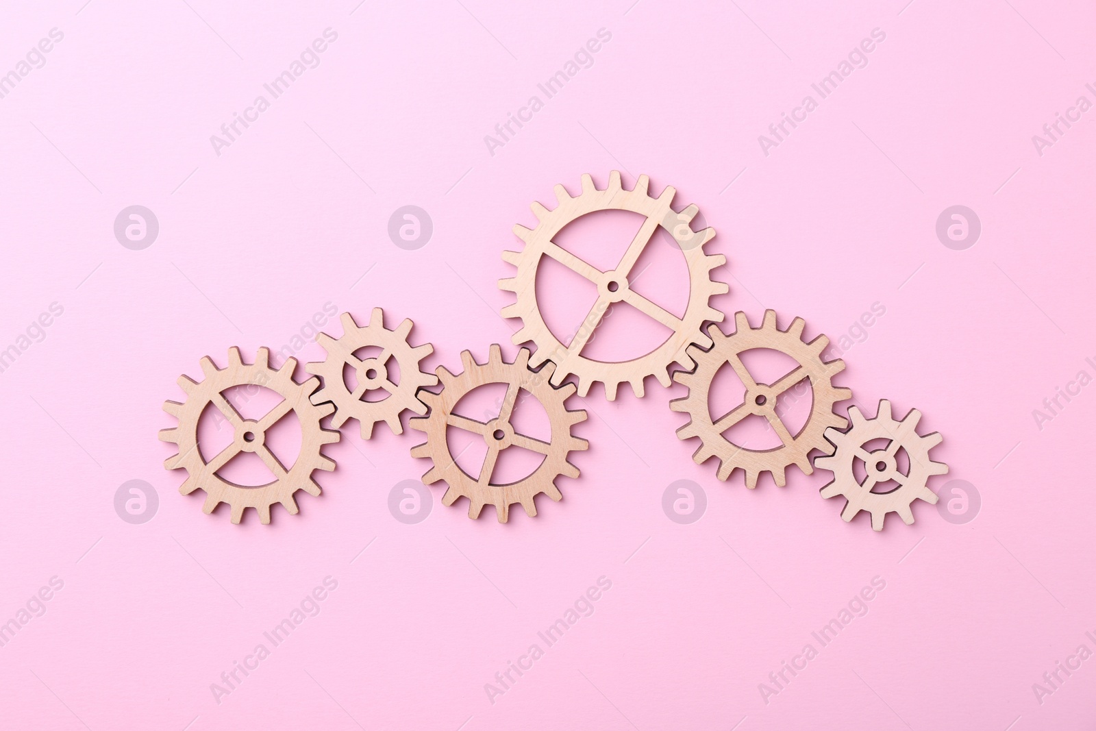 Photo of Business process organization and optimization. Scheme with wooden figures on pink background, top view