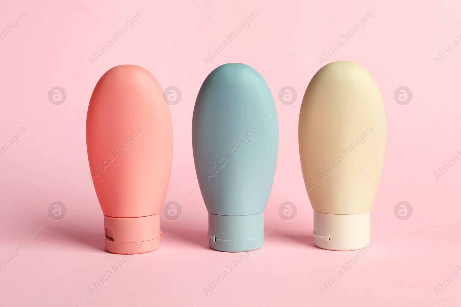 Photo of Cosmetic travel on pink background. Bath accessories