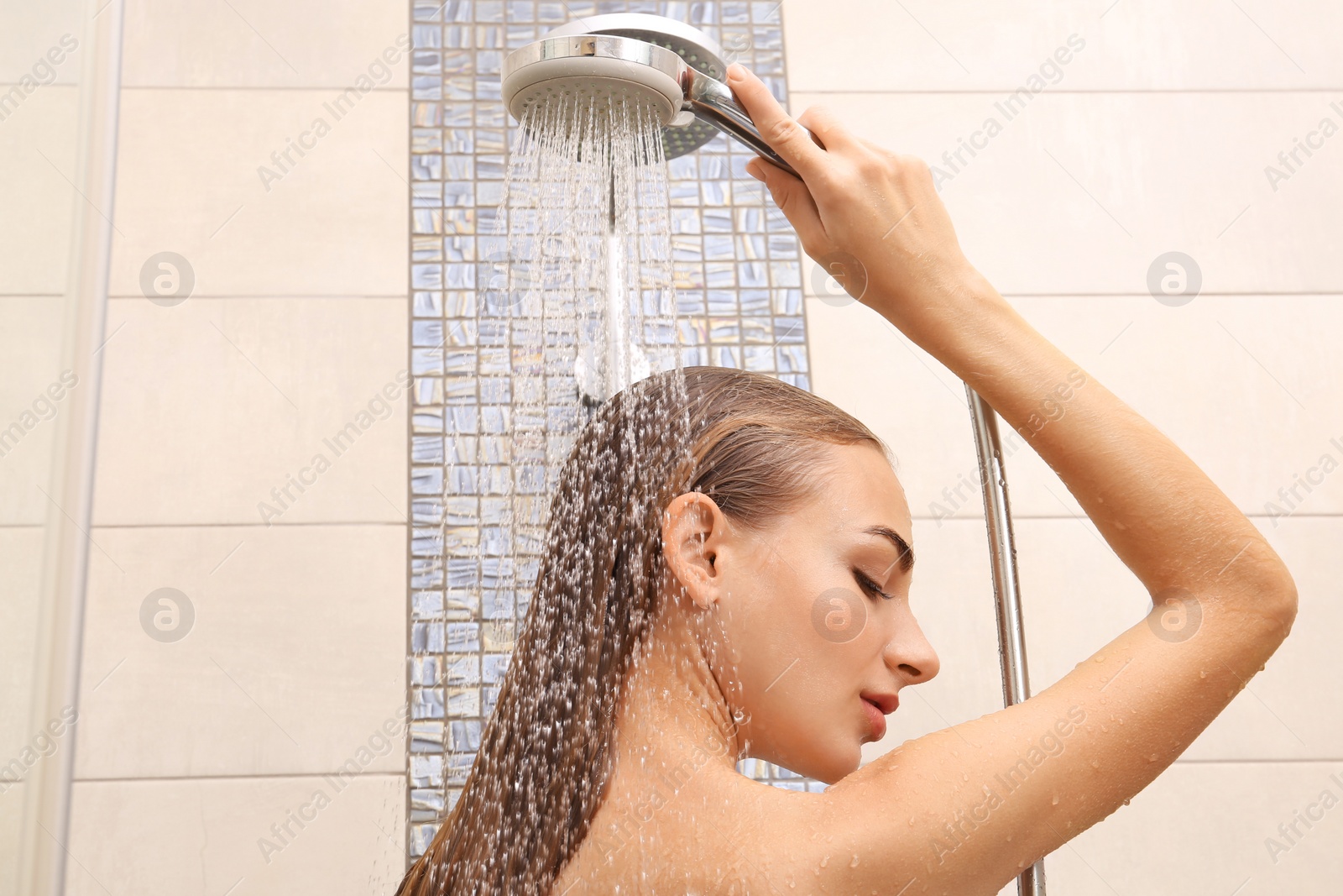 Photo of Beautiful young woman taking shower at home