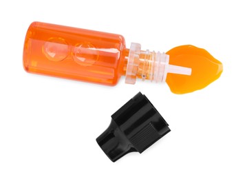 Photo of Bottle of orange food coloring on white background, top view