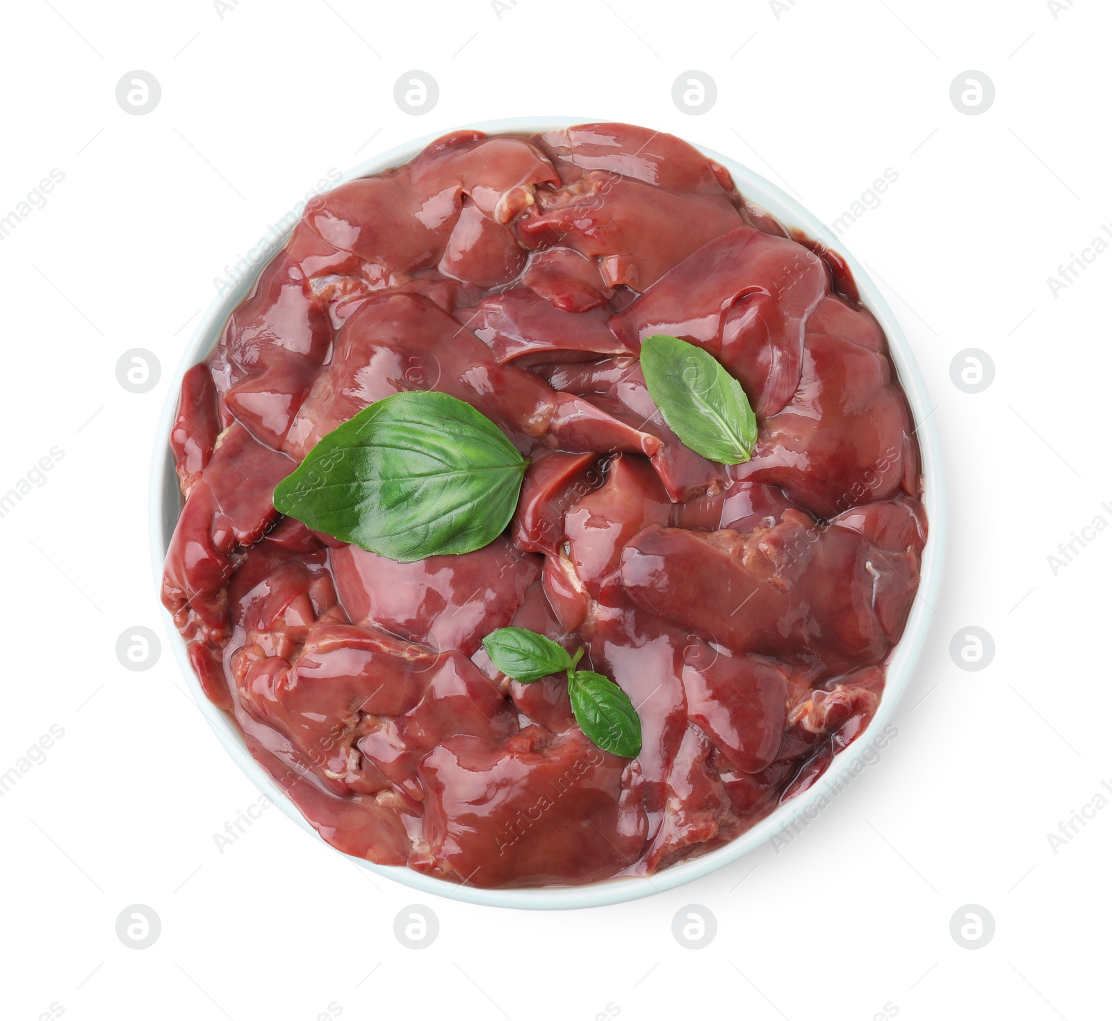 Photo of Plate of raw chicken liver with basil isolated on white, top view