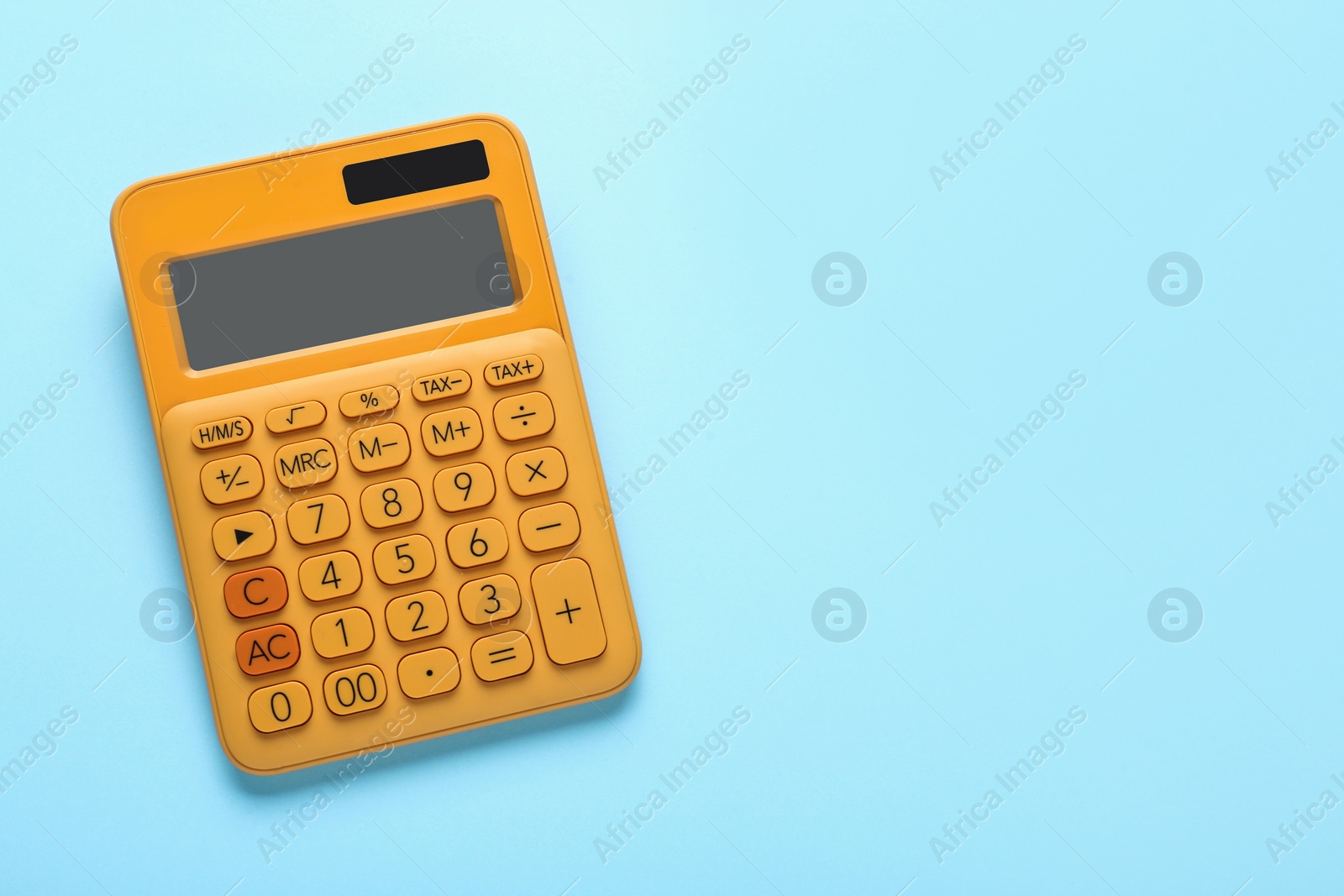 Photo of Orange calculator on turquoise background, top view. Space for text