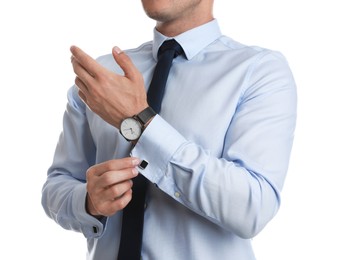 Photo of Stylish man putting on cufflink against white background, closeup