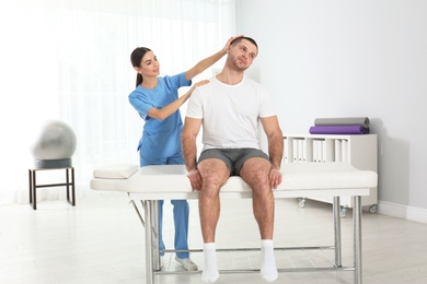 Photo of Doctor working with patient in hospital. Rehabilitation physiotherapy