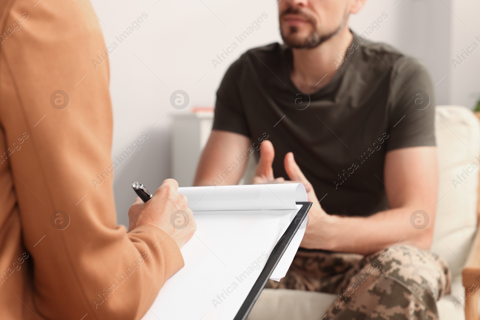 Photo of Psychologist working with military officer in office, closeup