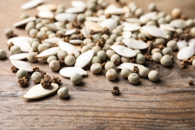 Mixed vegetable seeds on wooden background, closeup