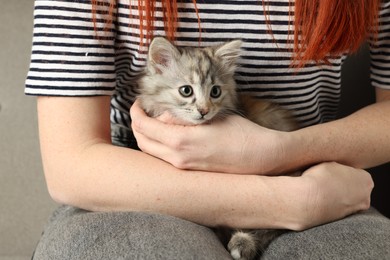 Photo of Woman with cute fluffy kitten, closeup view