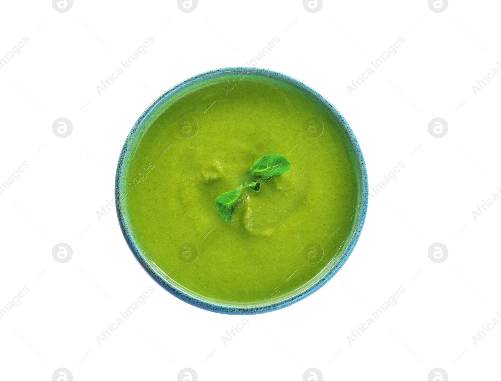 Photo of Bowl of broccoli cream soup with microgreens on white background, top view