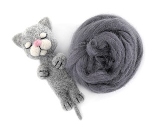 Photo of Needle felted cat and wool isolated on white, top view