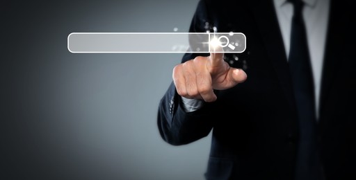 Man pointing at search bar on virtual screen against grey background, closeup. Banner design