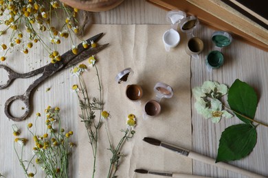 Photo of Flat lay composition with beautiful dried flowers and books on wooden table