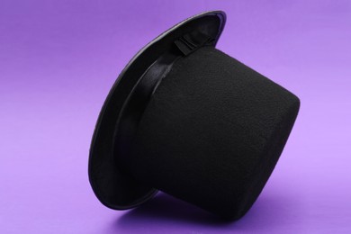 One magician top hat on violet background