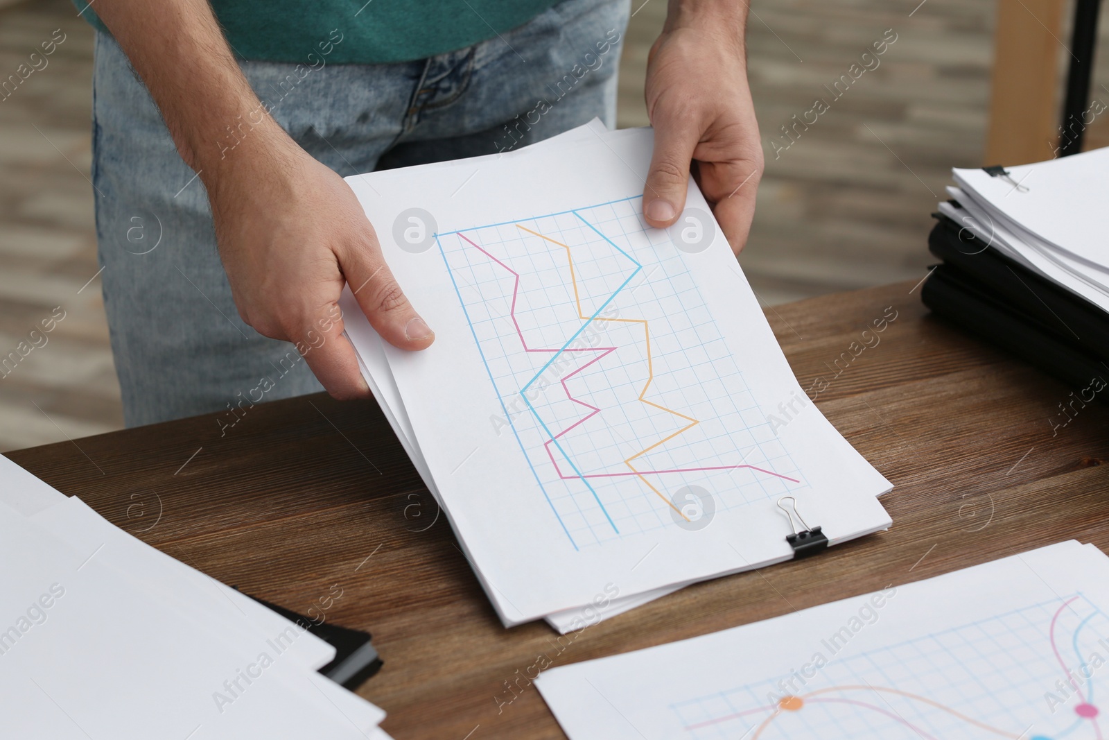 Photo of Businessman working with documents at office table, closeup