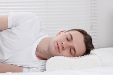 Photo of Man sleeping on orthopedic pillow at home