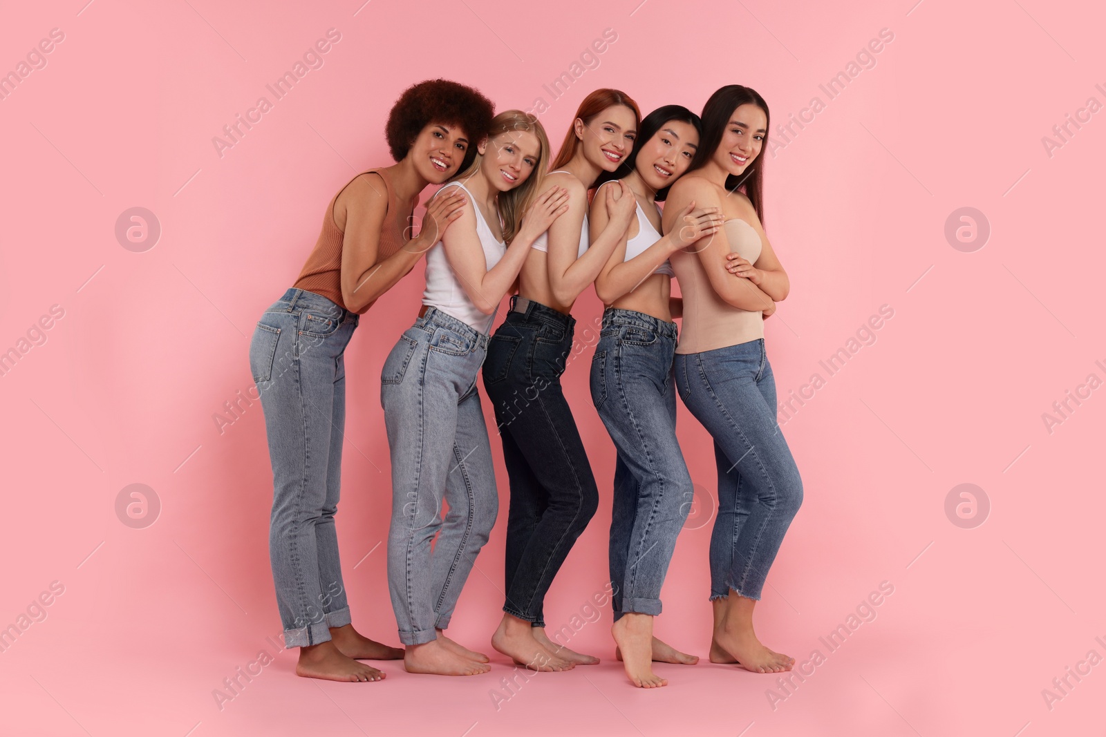 Photo of Group of beautiful young women on pink background