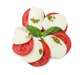Tasty salad Caprese with mozzarella, tomatoes, basil and pesto sauce isolated on white, top view