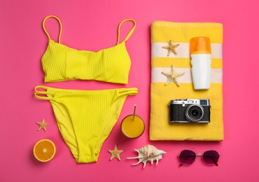 Flat lay composition with beach objects on pink background