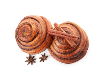 Freshly baked cinnamon rolls with ingredients on white background, top view